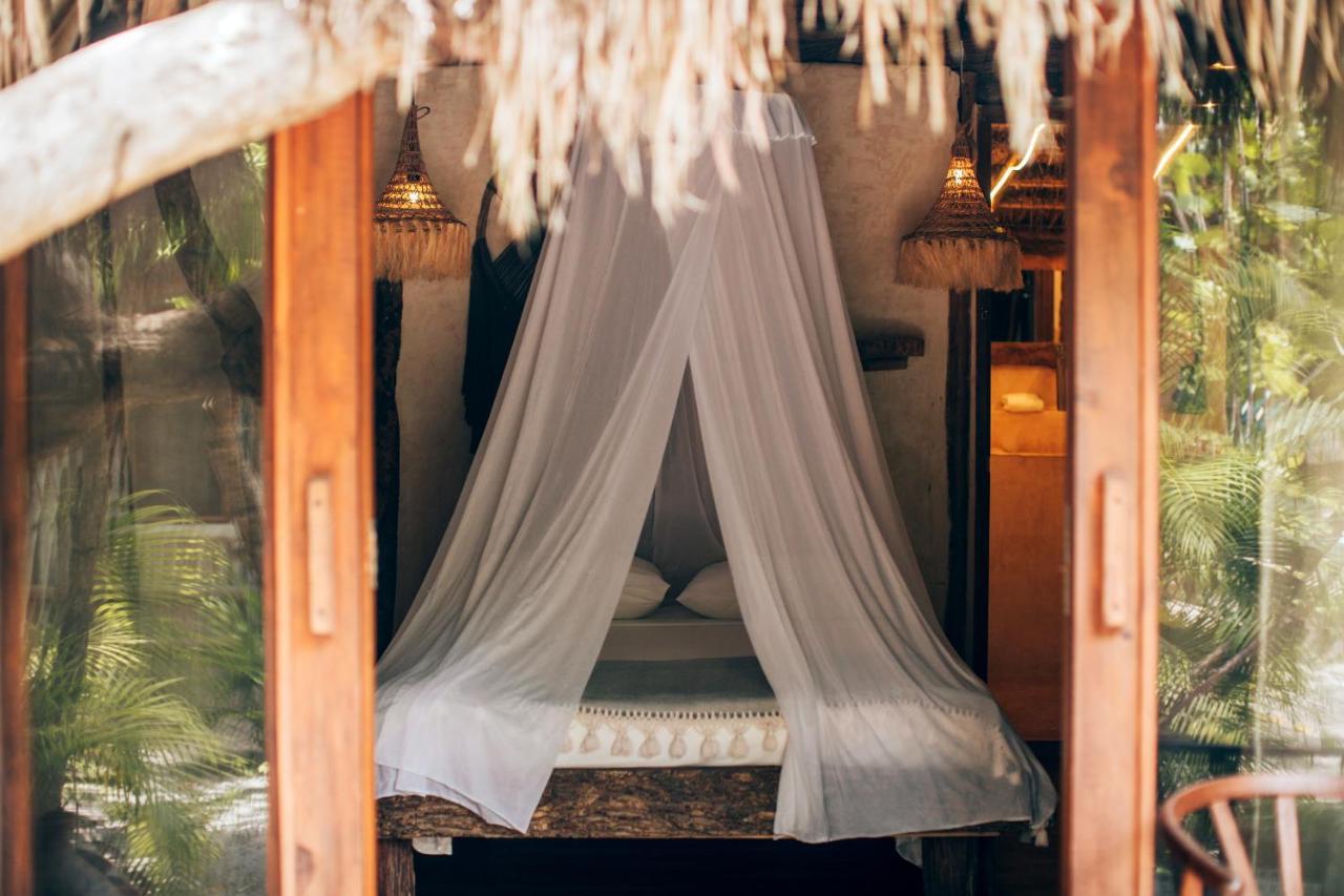 Ikal Tulum Hotel Exterior photo A mosquito net over a bed